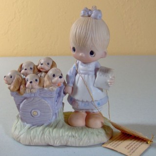 Precious Moments "Free Puppies" the figurine we spend YEARS looking for, and finally found. ;-)